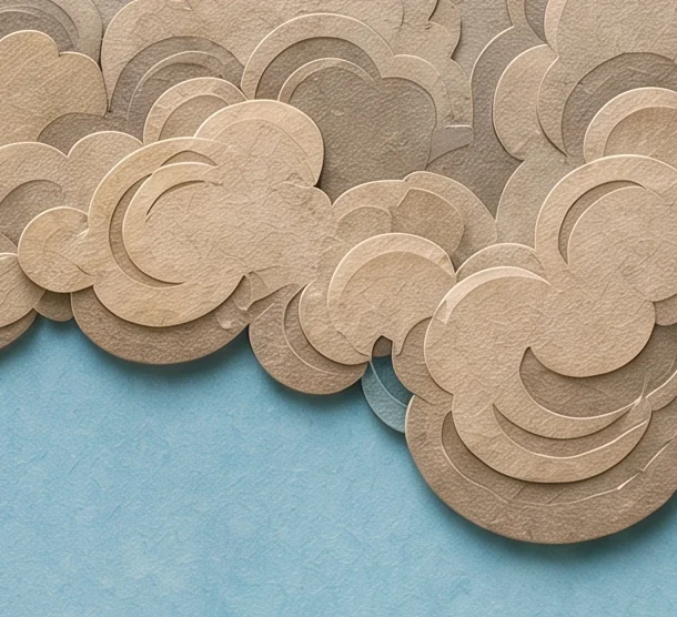 A bank of rounded grey-cream clouds against blue sky, with the dreamer's dark hand reaching in from the left and the bases of two golden cups above