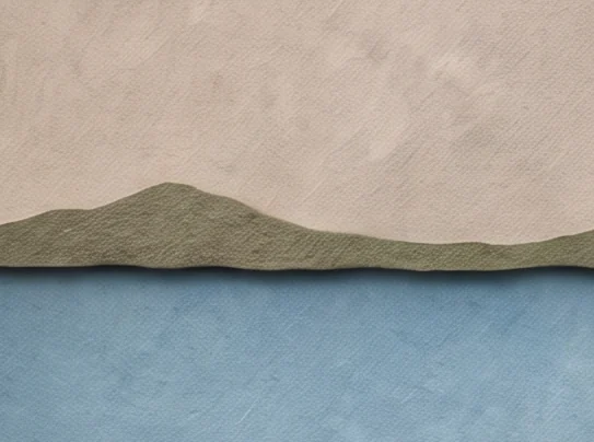 A low grey-green shore line across calm blue water under a pale grey sky, with the ferryman's shoulder in front